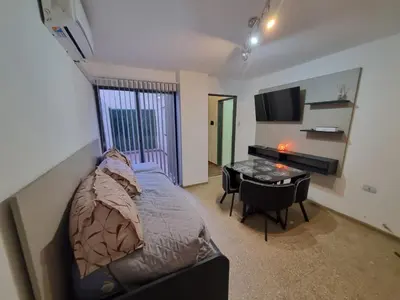 a bedroom with a bed and a desk and a table at TREJO APART, A 40MTS DEL PATIO OLMOS, PLANTA BAJA in Cordoba