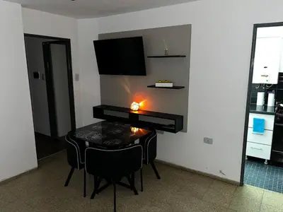 a living room with a table and a television at TREJO APART, A 40MTS DEL PATIO OLMOS, PLANTA BAJA in Cordoba