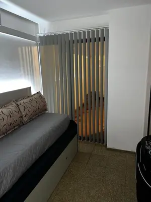 a room with a bed with a radiator and a window at TREJO APART, A 40MTS DEL PATIO OLMOS, PLANTA BAJA in Cordoba