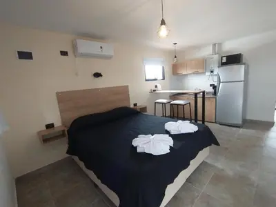 a bedroom with a bed with two towels on it at Apart Deluxe in Mina Clavero