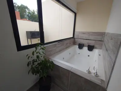 a large bath tub in a bathroom with a window at Apart Deluxe in Mina Clavero