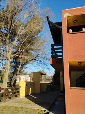 a building with a tree next to a fence at Paraíso Serrano 19 in Los Reartes