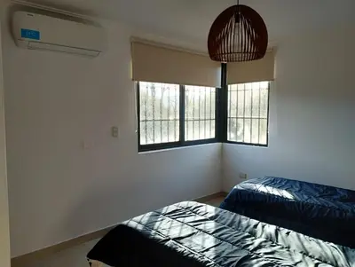 a bedroom with two beds and two windows at Paraíso Serrano 19 in Los Reartes
