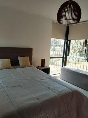 a bedroom with a large bed and a large window at Paraíso Serrano 19 in Los Reartes