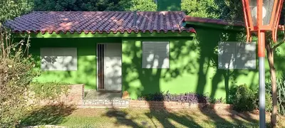 a small green house with a red roof at Casa Icho Cruz in Villa Icho Cruz