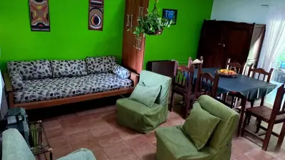 a living room with a couch and a table and chairs at Casa Icho Cruz in Villa Icho Cruz