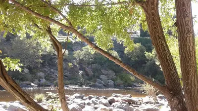 a view of a river with rocks and trees at Casa Icho Cruz in Villa Icho Cruz