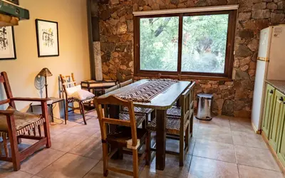 a kitchen with a table and chairs and a window at Magenta Complejo Cabañas & Spa in San Javier