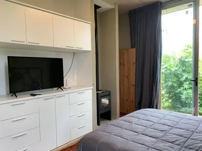 a bedroom with a bed and a flat screen tv at Magenta Complejo Cabañas & Spa in San Javier