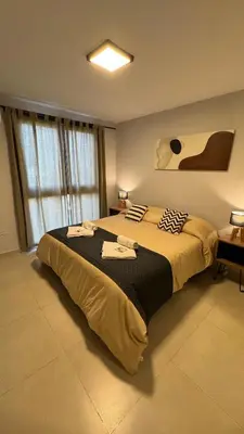 a bedroom with a large bed with towels on it at Guesthouse Park in Cordoba