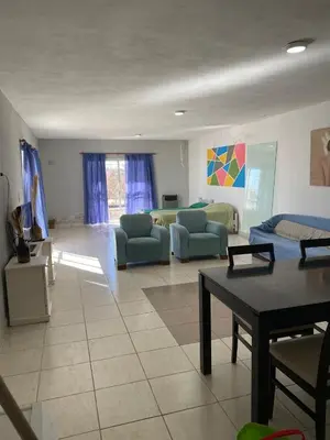 a large living room with couches and a table at Depto por día in Río Cuarto