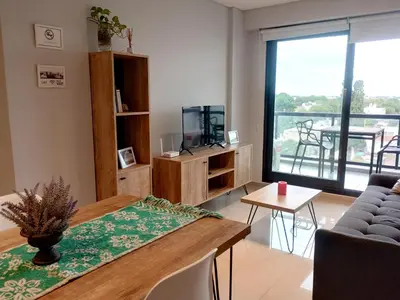 a living room with a table and a couch at Depto 1 dormitorio totalmente equipado in Cordoba