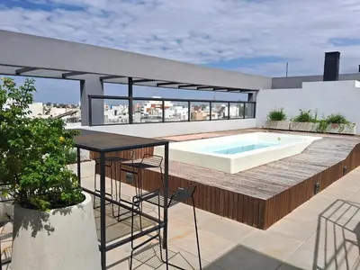 a swimming pool on the roof of a house at Depto 1 dormitorio totalmente equipado in Cordoba