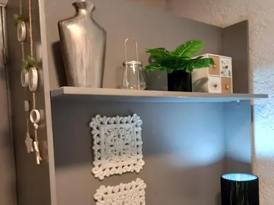 a shelf with a plant and a vase on it at Apartamento Nueva Cordoba in Cordoba