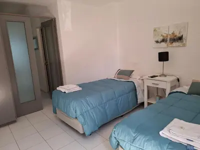 a room with two beds and a table with a lamp at Apartamento Nueva Cordoba in Cordoba