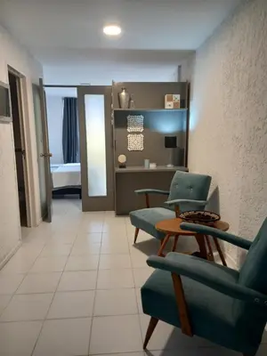 a living room with two chairs and a table at Apartamento Nueva Cordoba in Cordoba