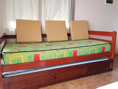 a bed with two boxes on top of it at Shakespeare 176 Ph3 in Villa Carlos Paz