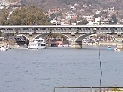 a bridge over a river with boats on the water at Shakespeare 176 Ph3 in Villa Carlos Paz