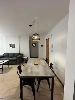 a living room with a table and a couch at Departamento Remodelado en Nva in Cordoba