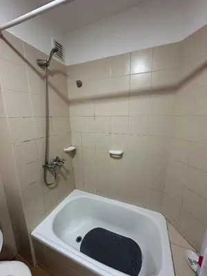 a bathroom with a tub with a black mat in it at Departamento Remodelado en Nva in Cordoba