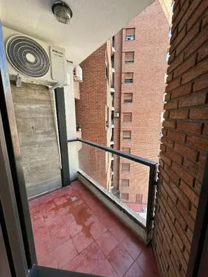 a balcony of a building with a window and a heater at Departamento Remodelado en Nva in Cordoba