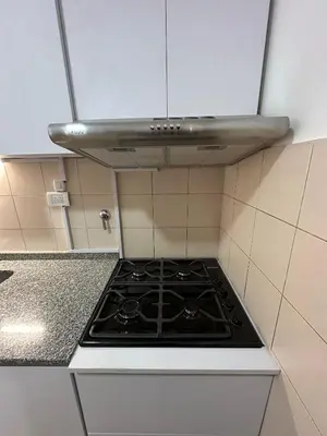 a kitchen with a stove top in a kitchen at Departamento Remodelado en Nva in Cordoba