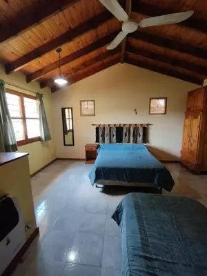 a bedroom with two beds and a ceiling fan at El descanso in Villa Ciudad Parque