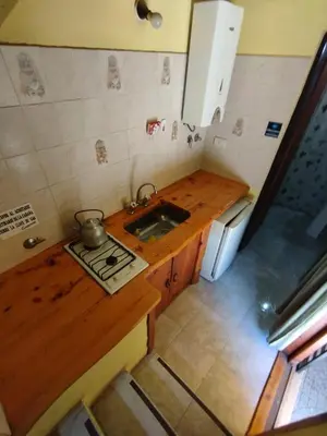 a small kitchen with a sink and a stove at El descanso in Villa Ciudad Parque