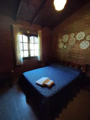 a bedroom with a blue bed with a book on it at El descanso in Villa Ciudad Parque