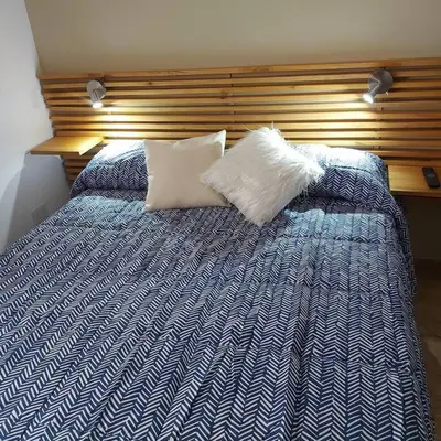 a blue and white bed with two pillows on it at Microcentro de la Docta in Cordoba