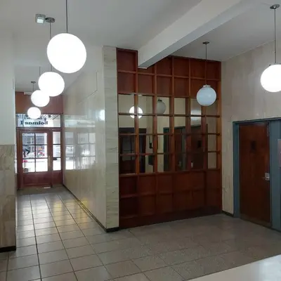 a lobby with wooden doors and lights in a building at Microcentro de la Docta in Cordoba