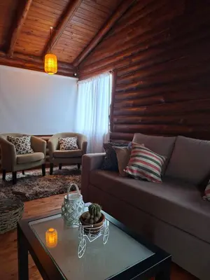 a living room with a couch and a table at La Autóctona in Villa Yacanto