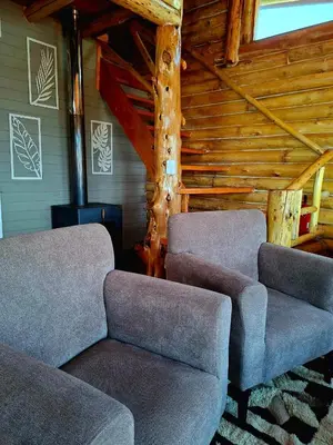 a living room with two chairs and a couch at La Autóctona in Villa Yacanto