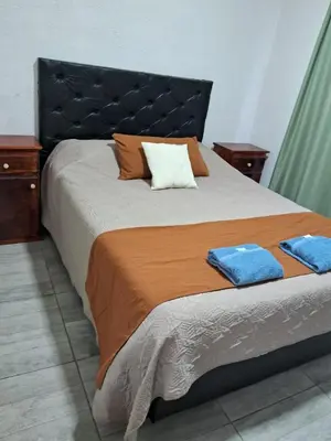 a bedroom with a large bed with two towels on it at pepesapart in Cordoba