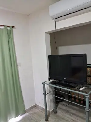 a living room with a tv and a table with a television at pepesapart in Cordoba
