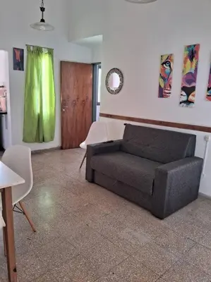 a living room with a couch and a table at comodidad y tranquilidad in Cordoba