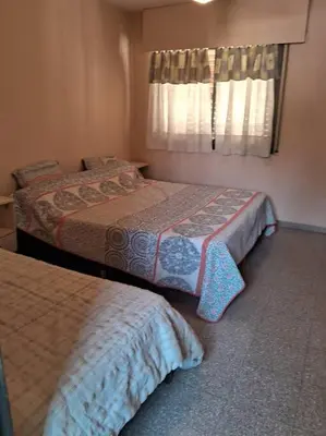 a bedroom with two beds and a window at comodidad y tranquilidad in Cordoba