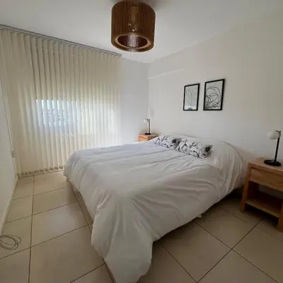 a bedroom with a large white bed in a room at Confort y seguridad in Cordoba