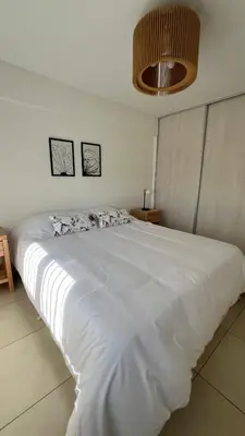 a large white bed in a white bedroom at Confort y seguridad in Cordoba