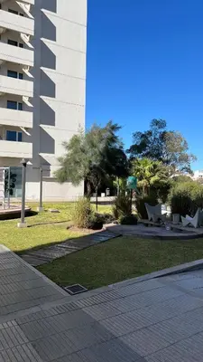 a building with a grassy area next to a building at Confort y seguridad in Cordoba