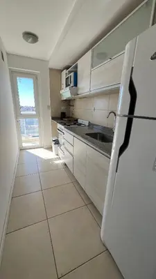 a kitchen with a white refrigerator and a window at Confort y seguridad in Cordoba