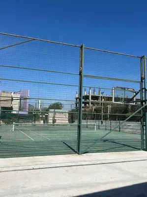 a tennis court with a net on a tennis court at Depto Villa Sol in Cordoba