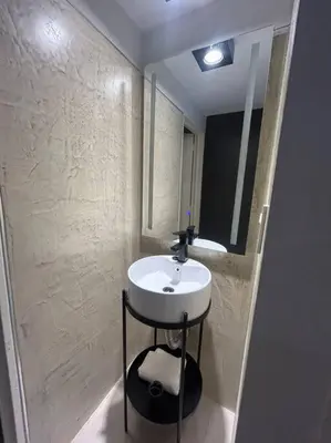 a bathroom with a sink and a mirror at Depto Villa Sol in Cordoba