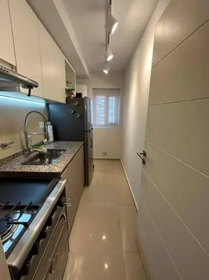a small kitchen with a sink and a stove at Depto Villa Sol in Cordoba