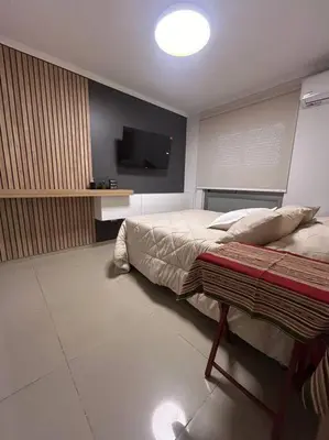 a bedroom with a bed and a flat screen tv at Depto Villa Sol in Cordoba