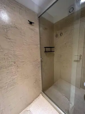 a shower with a glass door in a bathroom at Depto Villa Sol in Cordoba