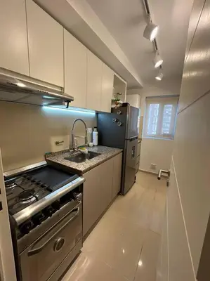 a kitchen with a stainless steel stove and refrigerator at Depto Villa Sol in Cordoba