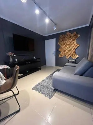 a living room with a couch and a flat screen tv at Depto Villa Sol in Cordoba