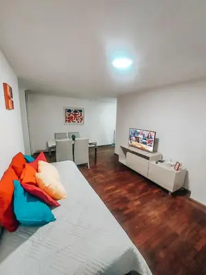 a bedroom with a bed and a couch and a tv at Departamento en NUEVA CÓRDOBA a cuadras de Plaza España y del consulado español in Cordoba