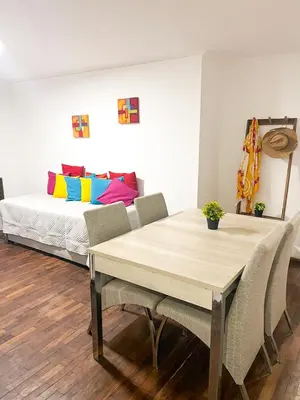 a dining room with a table and a bed at Departamento en NUEVA CÓRDOBA a cuadras de Plaza España y del consulado español in Cordoba